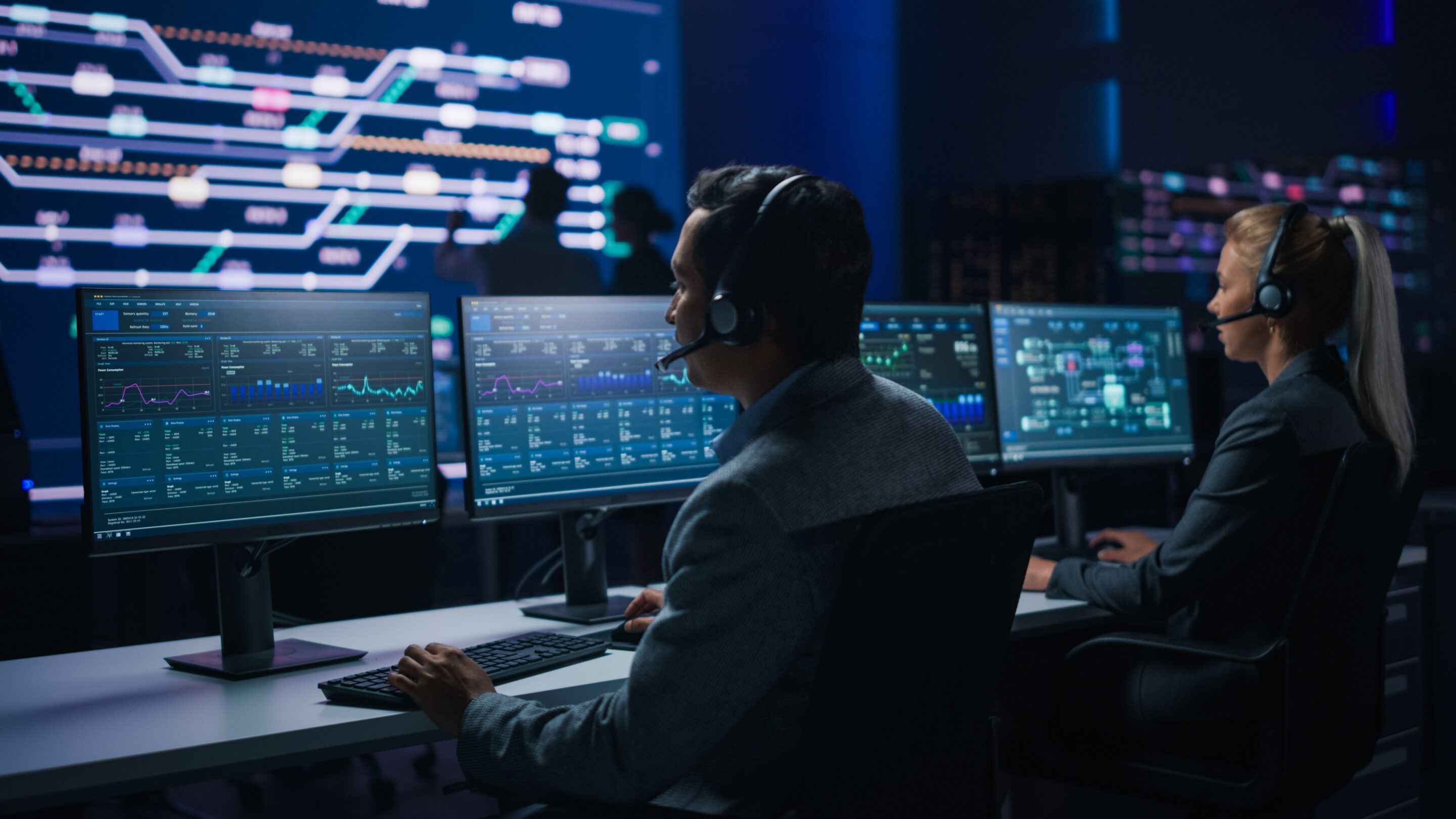 Team,Of,Professional,Traders,Talking,Into,Headsets,Work,On,Computers