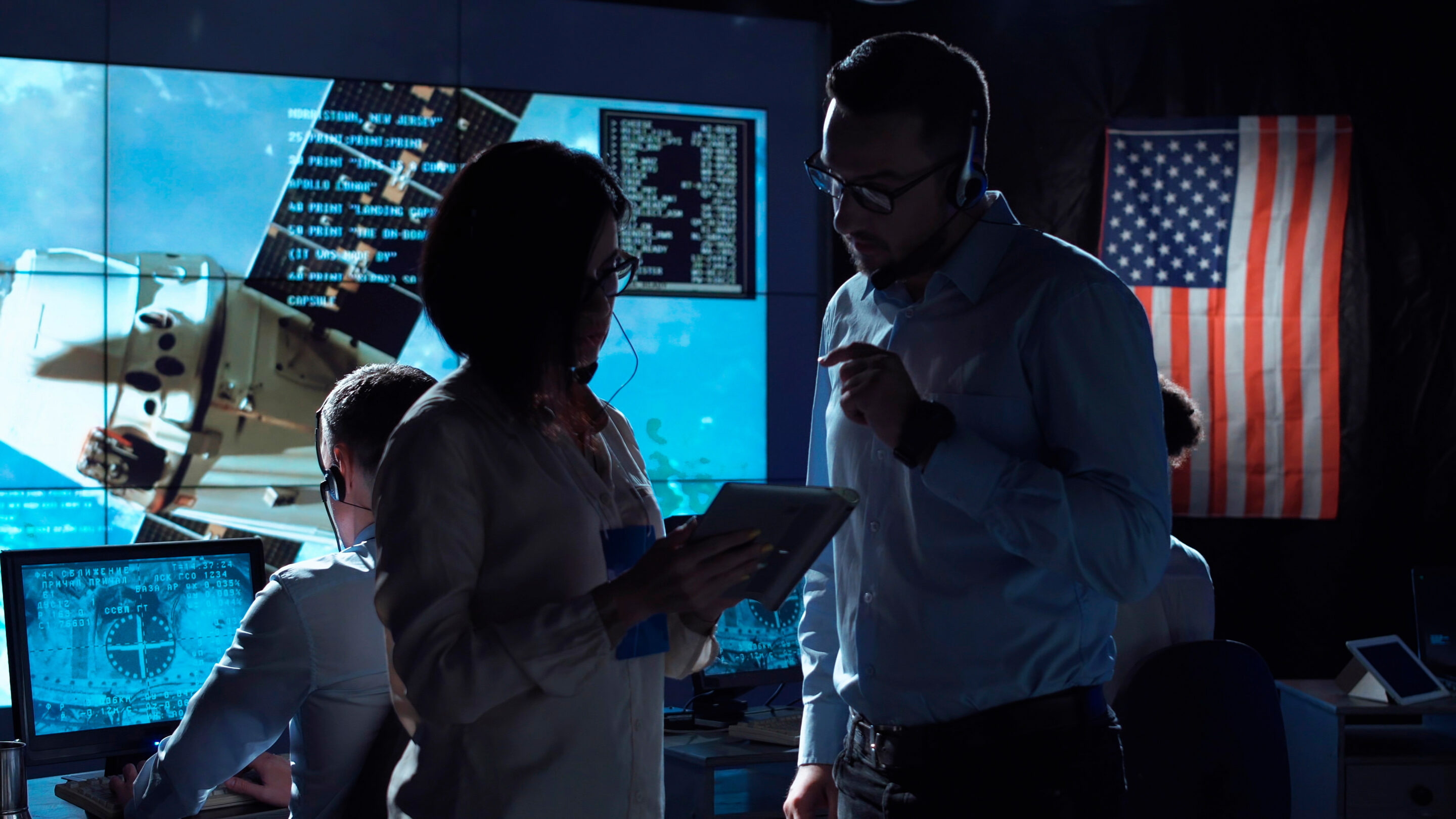 People communicating in space flight center